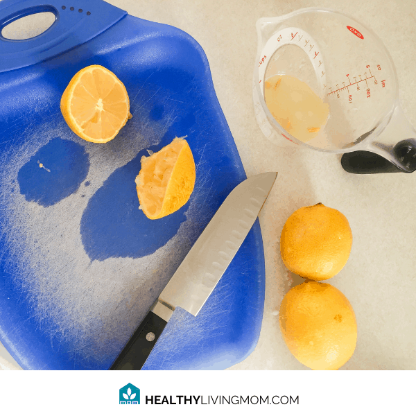 Lemon Sugar Scrub - Step 2 - Cut your lemon in half and squeeze the juice into another container that easily pours.