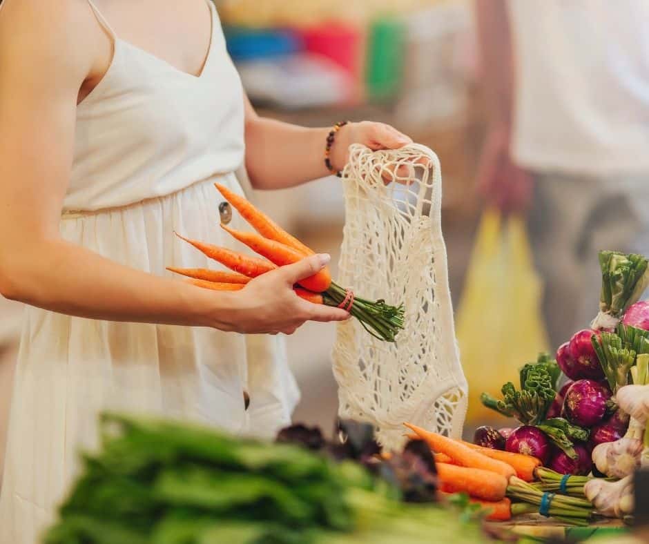 woman picking fresh carrots